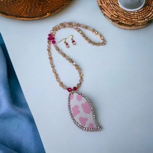 Pink beaded necklace with earrings and cow print pendant